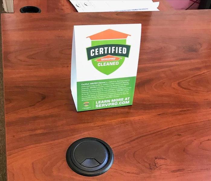 Our Certified: SERVPRO Clean logo at the front desk of the office