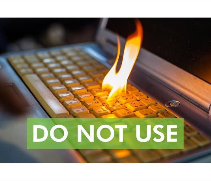 Computer keyboard with fire flame and the words DO NOT USE